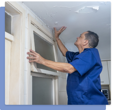 Photo of a man checking the ceiling damage